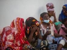 Women in Pemba await the possible arrival of a boat carrying their relatives evacuated from the town of Palma following a March 24 attack.